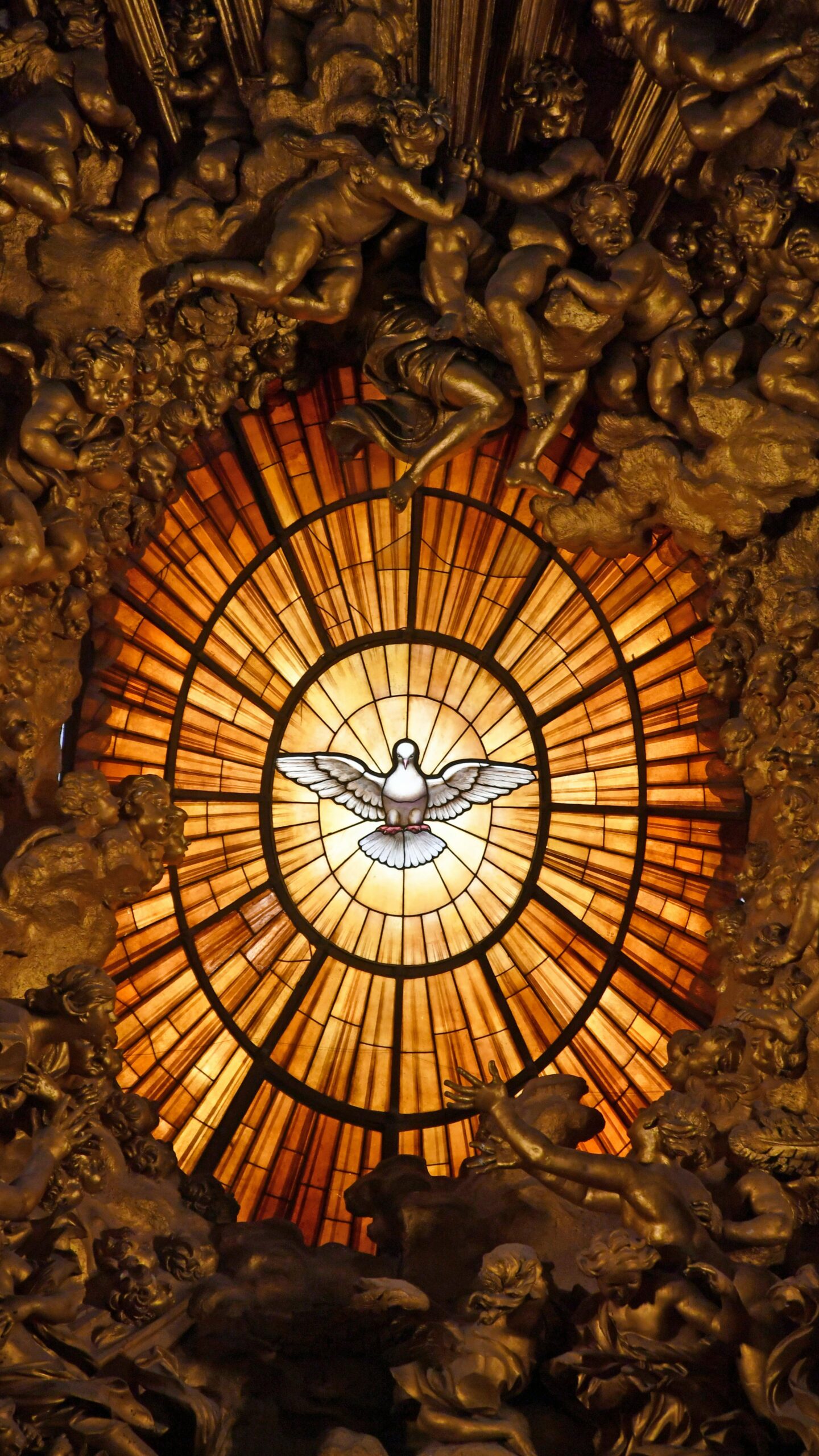 Testowa zbiórka Intricate stained glass window depicting the Holy Spirit as a dove, located in St. Peter's Basilica.
